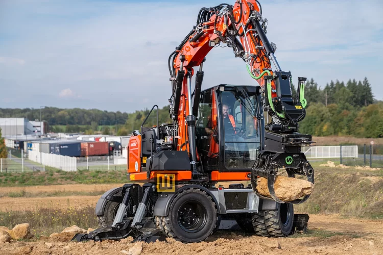 Koparka kołowa Kubota KW115 przemieszczanie materiału ciężkiego chwytakiem